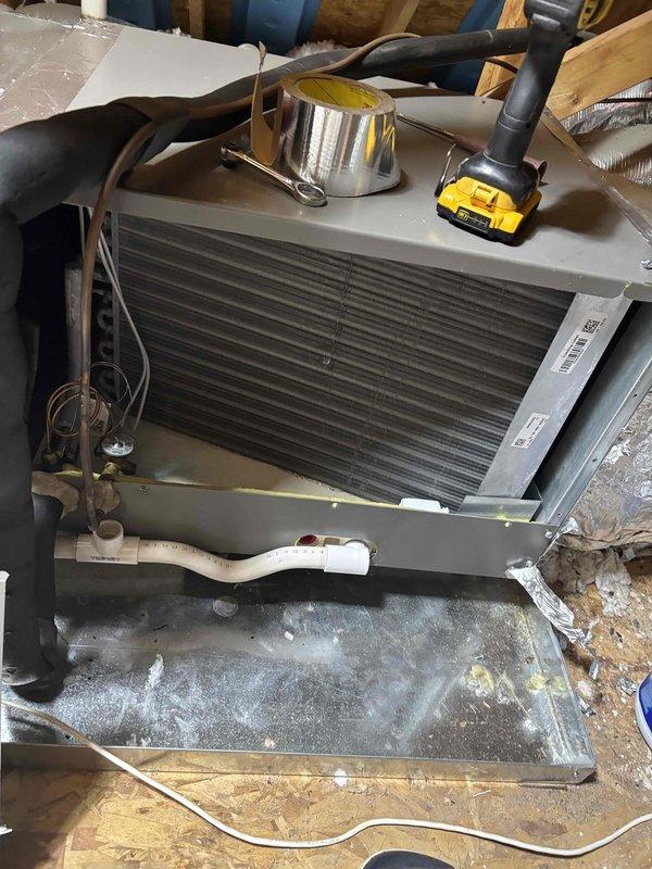 Completed second annual planned maintenance visit on dual HVAC systems, both approximately 2 years old. Performed comprehensive inspection of air handler unit located in attic space, replaced two 16x25x5 filters, checked refrigerant lines and drainage system, and verified proper condensate pan drainage with visible moisture present indicating system operation. Temperature readings confirmed proper system performance at 57.3°F, and all components were found operating within normal parameters for continued service under annual maintenance agreement.