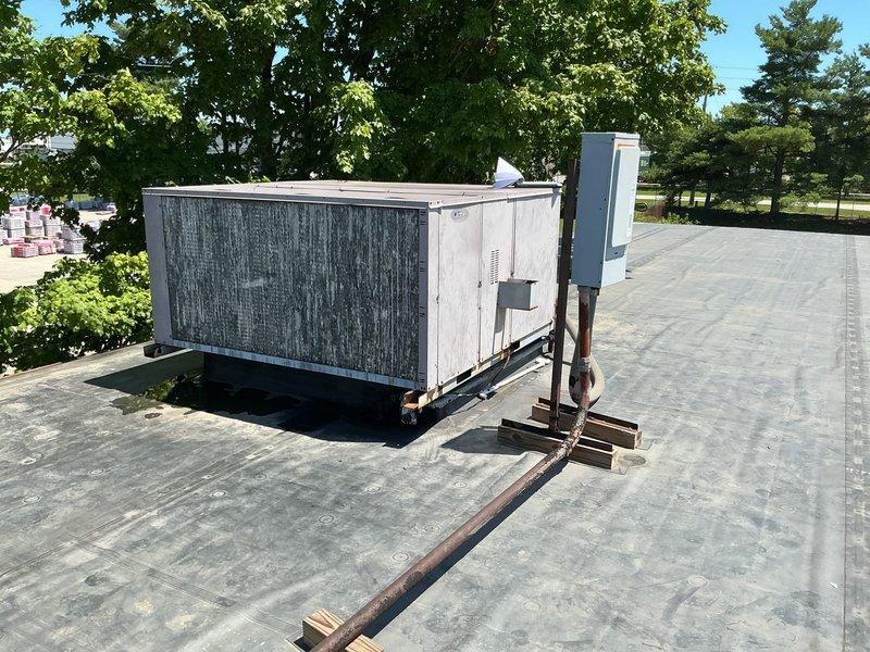 Completed follow-up site visit and documentation for rooftop HVAC system estimate. Photographed existing equipment conditions including heavily corroded piping, rusted metal fittings, and weathered PVC connections on commercial flat roof membrane. Documented rooftop unit placement, electrical disconnect box, support structures, and overall system accessibility for accurate proposal preparation.