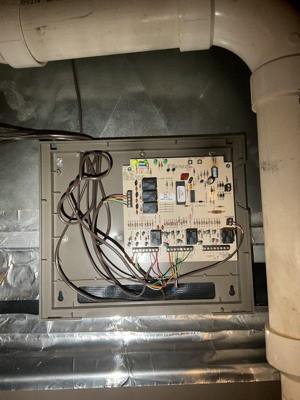 Responded to no cooling complaint on 5-year-old residential air conditioning system. Upon arrival, confirmed unit was running but not producing cold air with no visible ice buildup on indoor coil. Performed diagnostic inspection of both indoor air handler and outdoor condensing unit, examining electrical control board, relay connections, and wiring terminals. Inspected capacitors, contactors, and control circuitry for proper operation. Documented system components and electrical panel configuration for service records.