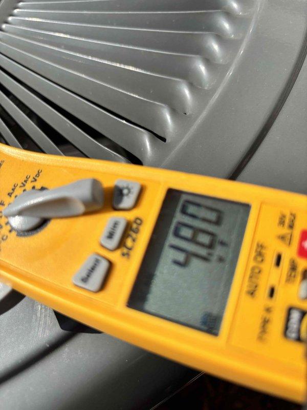 Responded to callback for recurring AC disconnect switch tripping on a 2-year-old system. Upon arrival, unit was operational as occupant had reset the disconnect. Performed comprehensive electrical diagnostics using digital multimeter to identify root cause of nuisance tripping. Tested voltage and amperage at disconnect switch and condenser unit, measuring 420V and verifying proper electrical parameters. Inspected compressor windings, contactor operation, and capacitor performance. All electrical readings within manufacturer specifications with no signs of short circuit, ground fault, or excessive amp draw that would cause disconnect to trip. Examined outdoor unit components including condenser fan motor and compressor for mechanical issues. Found no defects in equipment operation or wiring connections. System cooling properly with normal temperature differential. Documented findings with diagnostic photos showing test equipment readings and unit condition for warranty records.