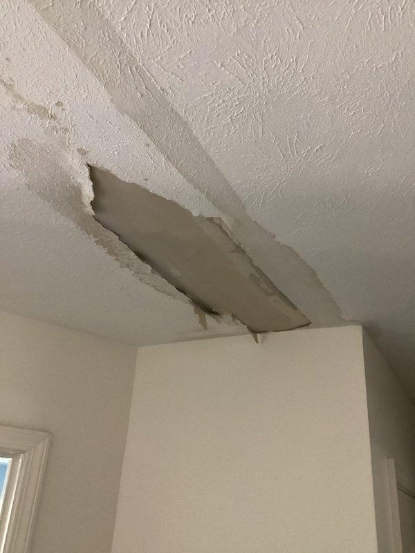 Responded to callback for attic HVAC unit now leaking with ceiling damage present. Upon arrival, observed significant water damage to interior ceiling with drywall separation and sagging material, along with visible water staining radiating from affected area. Unit had been shut down by occupant due to active leak. Previous service visit replaced failed capacitor that was reading low at 2.30 on a 45/5 rated unit, with new capacitor installed and verified at proper specifications. System was cycling correctly at time of initial repair, but leak developed overnight indicating secondary failure. Accessed attic unit and documented conditions showing water accumulation, debris, and deterioration around mechanical components. Inspection revealed condensate drainage issue or refrigerant leak causing moisture intrusion into living space below. Photographed ceiling damage extent and mechanical equipment condition for documentation. Unit remains off pending further diagnosis and repair of leak s