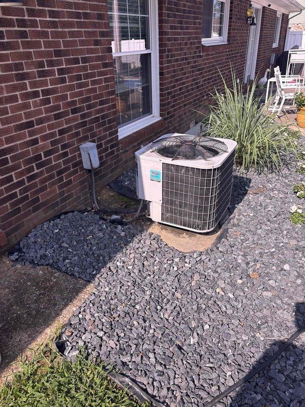 Conducted comprehensive replacement estimate for existing 25+ year old HVAC system with heat pump conversion evaluation. Assessed current operational cylindrical condenser unit with top-discharge configuration, electrical disconnect, and refrigerant line routing along exterior brick wall, as well as interior Honeywell Home thermostat. Documented existing equipment specifications, measured installation space requirements, evaluated electrical service capacity, and provided homeowner with heat pump replacement options to improve system efficiency and performance.
