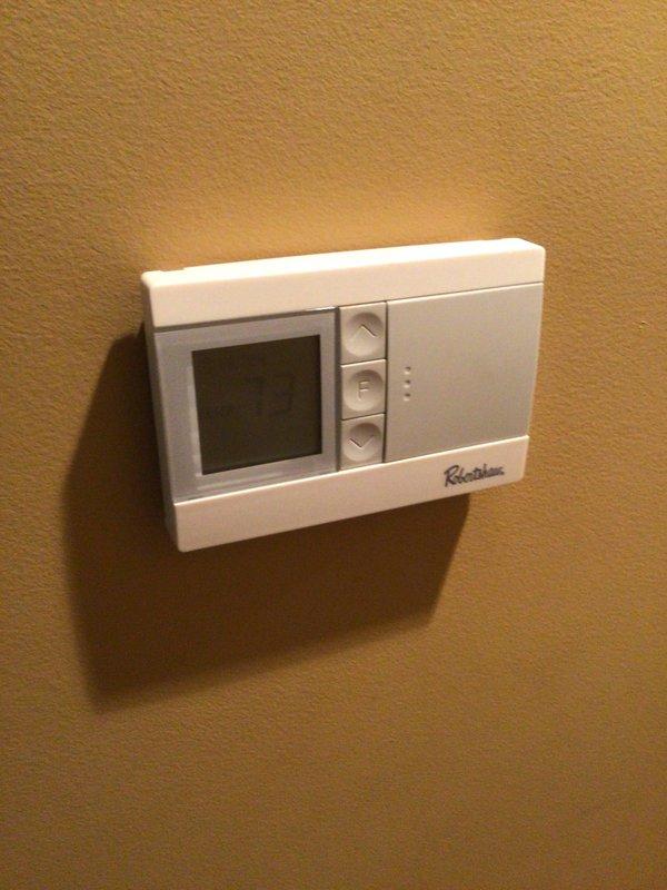 Conducted comprehensive assessment of existing HVAC system including Robertshaw digital thermostat and attic-mounted air handler unit with refrigerant lines and ductwork. Documented current system condition through detailed photography and discussed replacement options with homeowner, scheduling follow-up appointment for new system estimate with financing information.