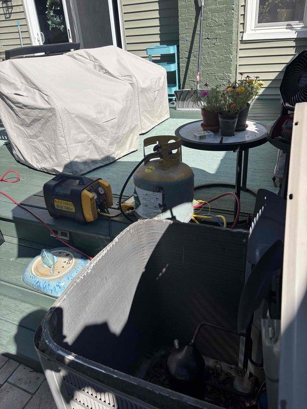 Conducted HVAC system diagnostics and repair preparation at residential property. Part staged and ready for installation with vacuum pump and recovery equipment positioned on-site per service protocol. Unit accessible and prepared for scheduled repair completion.
