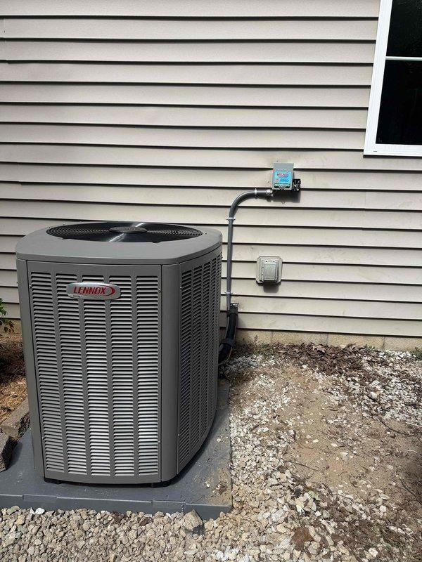 Completed full HVAC system installation including a 5-ton, 18 SEER outdoor Lennox condensing unit and upflow furnace with zoning capability. Installed indoor air handler with proper ductwork connections and sheet metal plenum in utility closet, routed condensate drain lines using white PVC piping, and ran electrical conduit from outdoor disconnect box to unit. Mounted outdoor condenser on composite pad with proper clearances from structure, installed electrical disconnect and junction boxes on exterior wall, and verified all refrigerant lines, electrical connections, and duct transitions are secure and sealed. System tested and operational with all zones functioning correctly.