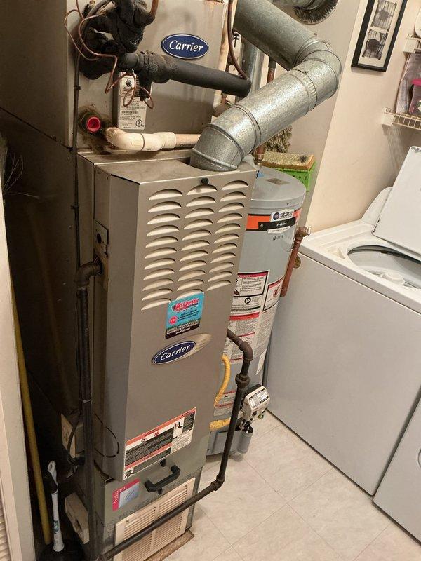 Completed monthly planned maintenance on a 21-year-old residential HVAC system. Inspected outdoor condenser unit and indoor Carrier furnace, replaced 14x20x5 air filter, verified proper operation of all components, and documented equipment condition with photographs.