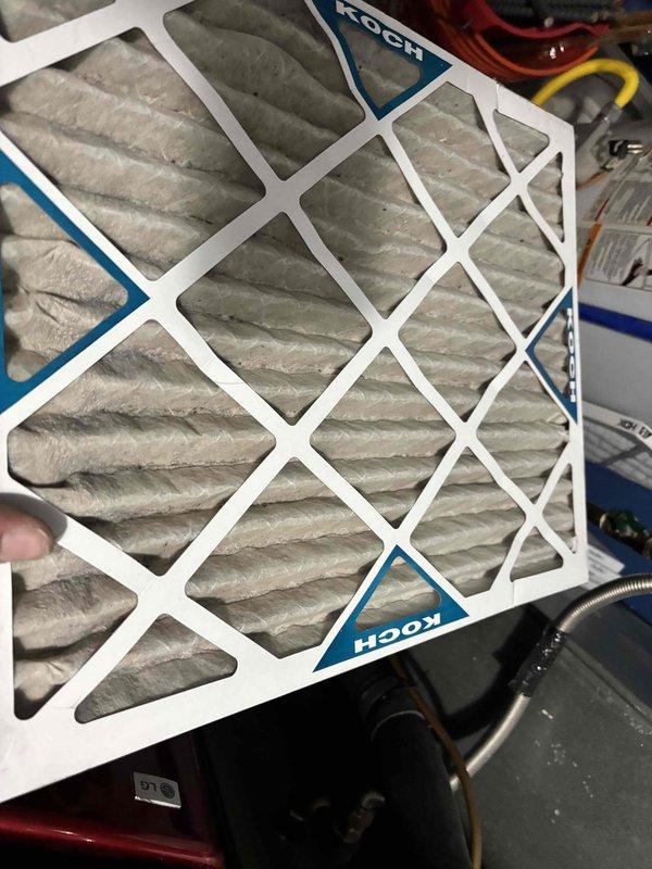 Responded to callback for inadequate cooling and ice buildup on two-year-old system. Previous service identified insufficient return airflow (600 CFM actual vs. 1200-1400 CFM required for 3-ton unit) and added utility room return with round duct, box, and grille to meet CFM requirements. Follow-up visit completed finishing work around spray foam insulation with tape as final remediation. Verified filter condition, confirmed system operating within manufacturer specifications with proper temperature split and refrigerant charge, and system now cooling effectively with adequate airflow.