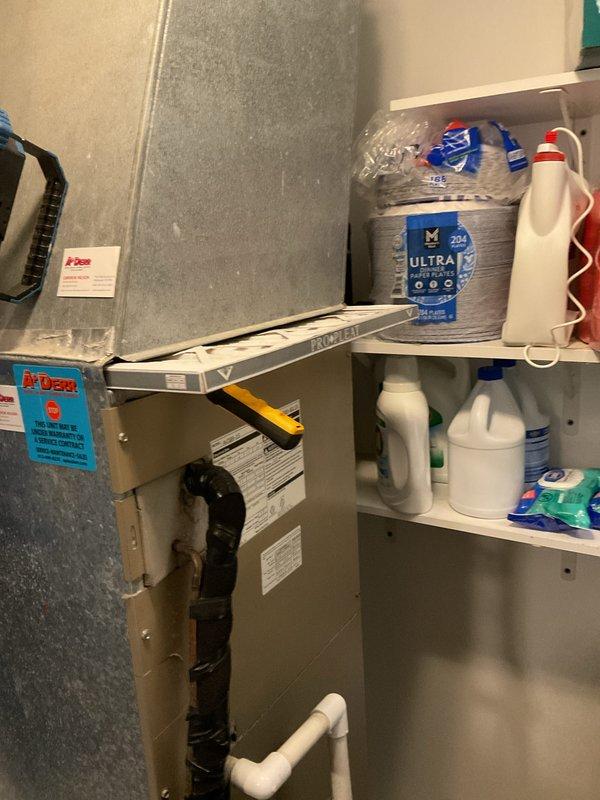 Responded to no cooling complaint on 10-year-old residential air conditioning system. Upon arrival, performed comprehensive diagnostic evaluation of both indoor air handler unit located in utility closet and outdoor condenser unit. Verified no ice buildup present on evaporator coil or refrigerant lines at indoor unit. Inspected outdoor condenser unit positioned on concrete pad against exterior wall, noting proper drainage and clear airflow around unit. Conducted system operational testing, checked refrigerant pressures, evaluated electrical connections at disconnect box, and assessed overall equipment performance. Documented equipment condition with photographic records of both indoor and outdoor components for service history.