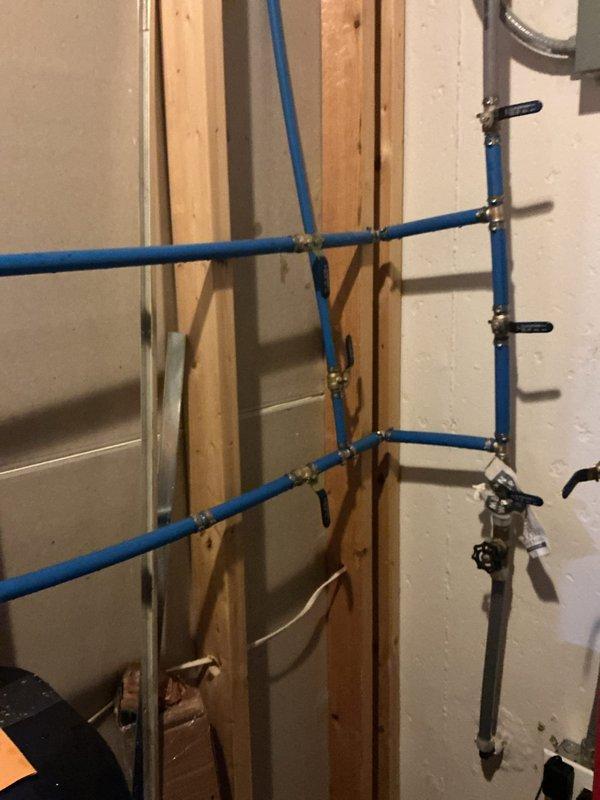 # Plumbing Repair Completion

Completed installation of PEX water supply line system in utility area with proper securing and shut-off valve integration. Replaced deteriorated plumbing components in basement mechanical space, addressing previous moisture damage and upgrading drainage system with new PVC piping and couplings. All water lines properly fastened to wall framing with metal clamps, electrical wiring routed safely, and system tested for proper operation prior to wall closure.