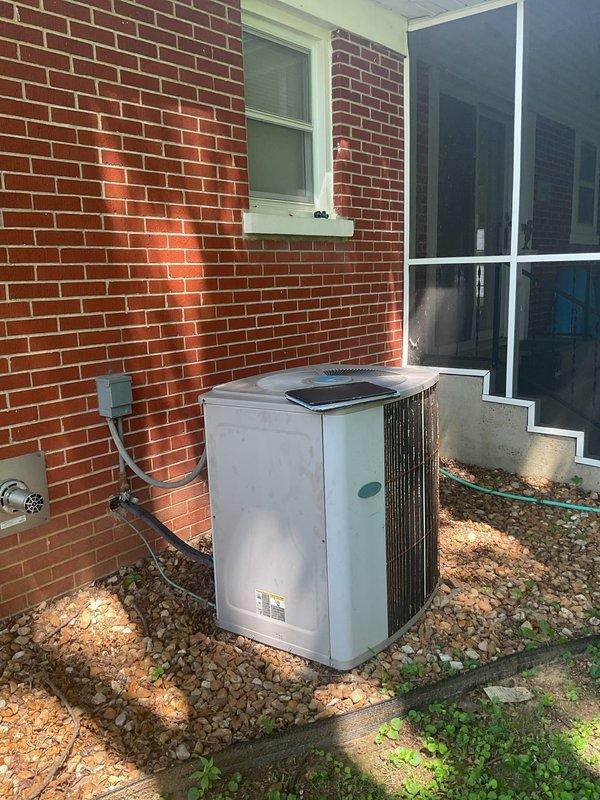 Conducted comprehensive HVAC system replacement estimate at residential property with existing operational equipment. Evaluated outdoor condensing unit positioned on gravel pad against brick exterior wall, assessed refrigerant line routing and structural mounting conditions. Inspected interior ductwork system including flexible aluminum ducting, examined basement ceiling-mounted distribution network, evaluated existing electrical connections and junction box locations to determine replacement specifications and compatibility requirements for new high-efficiency system installation.