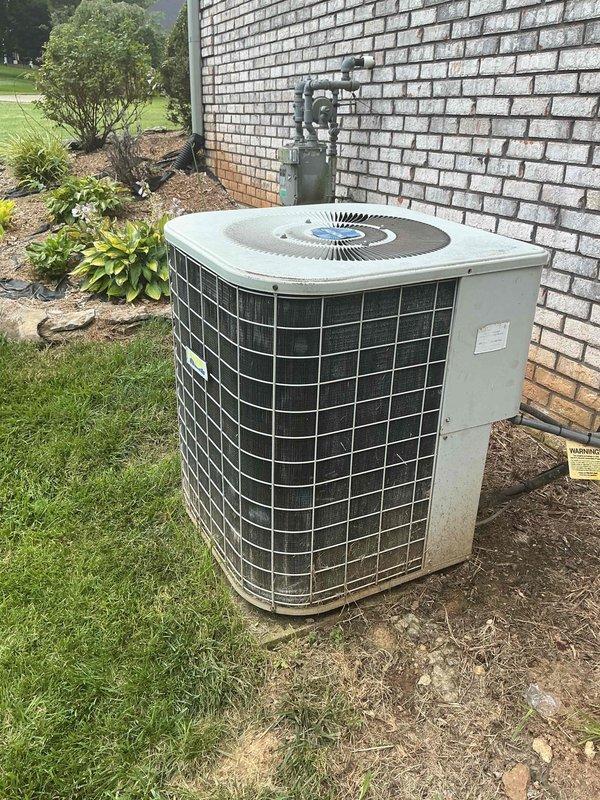 Responded to service call for non-operational air conditioning system affecting entire residence. Upon arrival, evaluated 26-year-old outdoor condensing unit positioned on grade adjacent to building foundation with electrical disconnect mounted on exterior brick wall. Conducted comprehensive system assessment and determined unit had reached end of serviceable life at 26 years of age, well beyond typical equipment lifespan. Documented existing installation configuration including electrical connections, refrigerant line routing, and equipment placement. Presented replacement options and provided detailed estimate for complete HVAC system replacement with energy-efficient equipment upgrade to restore cooling capacity to residence.