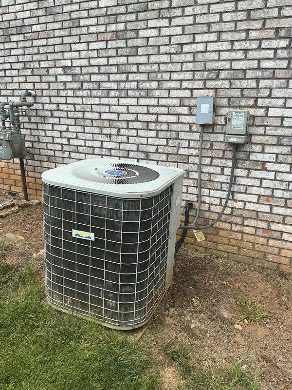 Responded to service call for non-operational air conditioning system affecting entire residence. Upon arrival, evaluated 26-year-old outdoor condensing unit positioned on grade adjacent to building foundation with electrical disconnect mounted on exterior brick wall. Conducted comprehensive system assessment and determined unit had reached end of serviceable life at 26 years of age, well beyond typical equipment lifespan. Documented existing installation configuration including electrical connections, refrigerant line routing, and equipment placement. Presented replacement options and provided detailed estimate for complete HVAC system replacement with energy-efficient equipment upgrade to restore cooling capacity to residence.