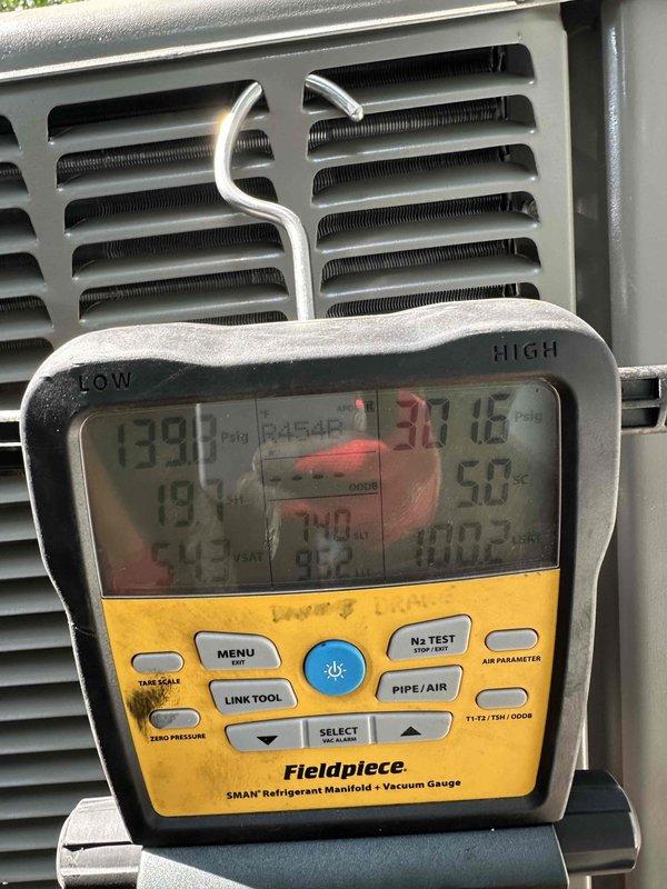 Completed installation of 2-ton, 16 SEER heat pump system with air handler for upstairs zone, including outdoor condenser unit positioned on gravel pad and indoor air handler with 17x21 filter. System was properly commissioned with refrigerant pressures verified using manifold gauges, confirming operational parameters within manufacturer specifications.