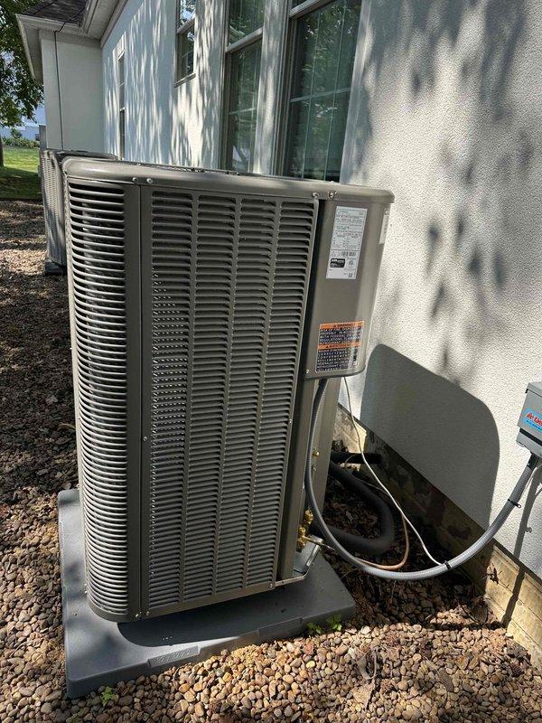 Completed installation of 2-ton, 16 SEER heat pump system with air handler for upstairs zone, including outdoor condenser unit positioned on gravel pad and indoor air handler with 17x21 filter. System was properly commissioned with refrigerant pressures verified using manifold gauges, confirming operational parameters within manufacturer specifications.