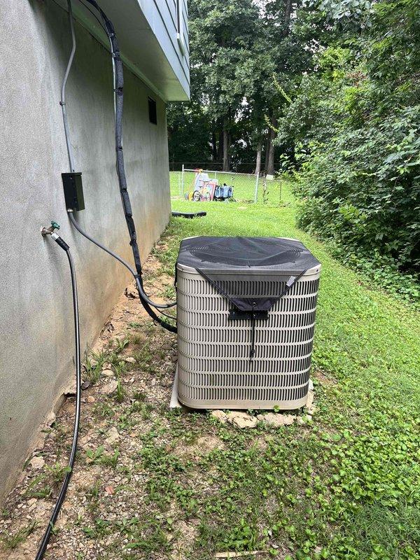 Conducted comprehensive HVAC replacement estimate at residential property. Evaluated existing outdoor air conditioning unit with ribbed metal exterior and protective cover, noting equipment condition and placement adjacent to building exterior. Assessed electrical infrastructure including main breaker panel with handwritten circuit directory identifying HVAC circuits, evaluated electrical connections and capacity for potential system replacement, and documented current system configuration to provide homeowner with equipment upgrade options and installation requirements.