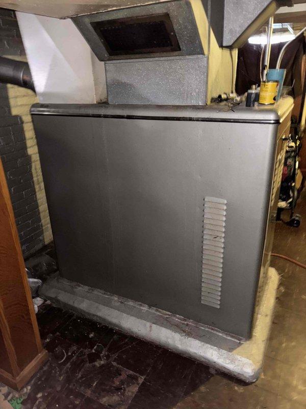 Responded to no-cool call on 10+ year old system located in basement. Upon arrival, thermostat set to 70°F with ambient temperature reading 80°F. Customer reported significantly reduced airflow to bedroom and dining room, with minimal to no air delivery, while other areas of home maintained adequate airflow. No tripped breakers reported, and no ice buildup observed on evaporator coil or furnace area.

Performed system inspection and diagnosed failed blower motor belt. Belt showed significant wear and deterioration consistent with age and use. Blower motor unable to operate effectively, resulting in insufficient air circulation throughout duct system and complete loss of cooling capacity. Photographed existing belt showing model number 15J480 for replacement part ordering.

Part ordered for follow-up appointment to replace blower belt and restore system operation. Estimated repair time 30 minutes upon part arrival. Coordinated with supervisor for installation walkthrough. System remains