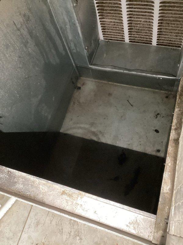 Responded to emergency service call for active water leak from central HVAC system flowing onto kitchen floor. Upon arrival, accessed unit through basement crawl space and inspected condensate drainage system. Found primary condensate drain line completely blocked, causing overflow from drain pan. Cleared obstruction from condensate line using appropriate tools and verified proper drainage flow. Inspected drain pan for cracks or damage and confirmed structural integrity. Tested system operation to ensure condensate was draining correctly without backup. Cleaned accumulated debris from affected areas and verified no further leakage present during extended run cycle.
