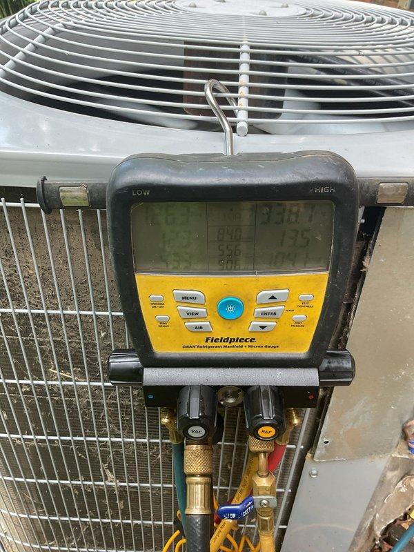 Responded to no cooling complaint on downstairs 5-year-old residential split system. Upon arrival, verified thermostat set to cooling mode at 76°F with system running but inadequate cooling to conditioned space. Proceeded to outdoor condensing unit and performed comprehensive system diagnostics using refrigerant manifold gauges and digital analyzer. Measured refrigerant pressures on both low and high side to assess system charge and performance parameters. Evaluated compressor operation, condenser fan motor function, and airflow across coil. System diagnostics revealed operational deficiency requiring further assessment of refrigerant charge levels and overall cooling capacity to restore proper temperature control to affected zone.