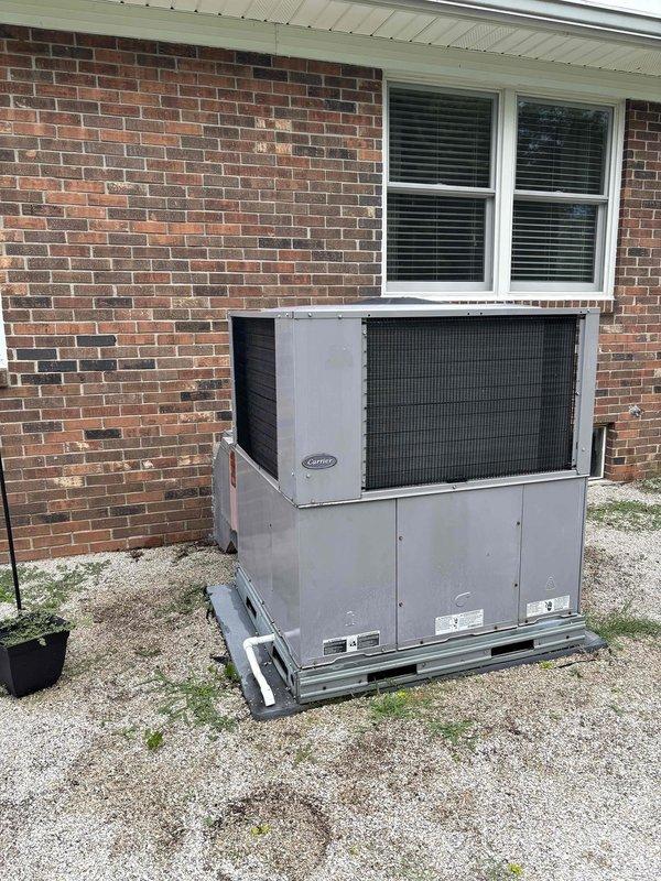 Completed annual Gold Level planned maintenance on 5-year-old residential HVAC system. Performed comprehensive inspection of outdoor unit positioned on gravel pad, verified proper operation of packaged heat pump system, and replaced 20x20x5 air filter. Documented condenser coil condition showing moderate dust and debris accumulation between fins, recommended future coil cleaning to maintain optimal heat transfer efficiency and system performance.