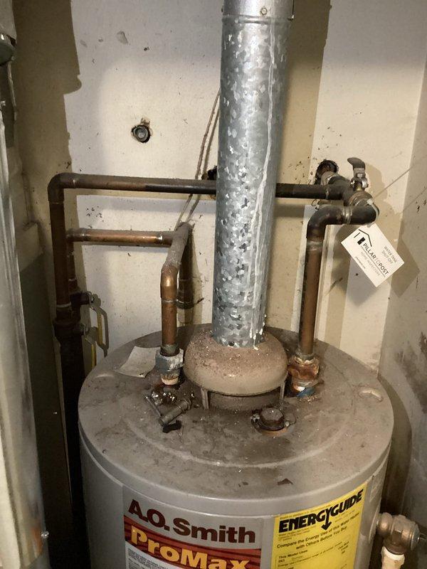 Conducted comprehensive on-site estimate for tankless gas water heater installation. Evaluated existing A.O. Smith ProMax tank-style water heater and associated plumbing infrastructure, including copper supply lines, gas connections, and venting system. Assessed current ductwork condition, noting deterioration and mineral deposits on galvanized venting components. Documented electrical controls, mechanical systems integration, and utility room configuration to determine optimal placement and requirements for tankless conversion. Photographed existing installation, pipe routing, and structural considerations necessary for proper sizing and specification of new tankless gas unit.