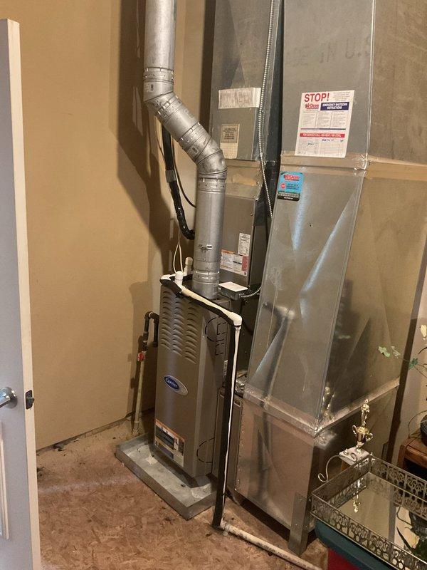 Responded to service call for non-functional downstairs air conditioning system. Upon arrival, evaluated 22-year-old HVAC system including Carrier furnace and air handler assembly located in interior utility closet. Inspected thermostat wiring configuration and documented existing equipment condition through comprehensive photography of system components, wiring terminals, and installed hardware. Prepared detailed replacement estimate for complete HVAC system upgrade due to age and operational failure of existing equipment.