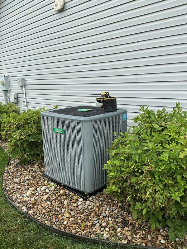 Completed second scheduled maintenance visit on a 6-year-old residential HVAC system under Gold Level maintenance plan with 20x25x5 filter specification. Performed comprehensive electrical diagnostics using calibrated digital multimeter, verifying voltage readings and system performance at the control panel and terminal connections. Conducted exterior condenser unit inspection, confirmed proper installation with adequate clearance, verified landscaping integration with river rock base and protective edging maintained appropriate distance from unit for airflow optimization.