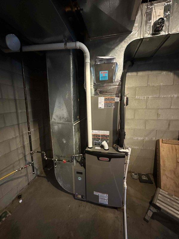 Completed installation of a 5-ton, 18 SEER Lennox upflow furnace system with i-Harmony communicating zoning technology in basement mechanical room. System was properly commissioned with refrigerant manifold gauges confirming optimal pressures and temperatures, all ductwork connections secured, and communicating controls verified for multi-zone operation.