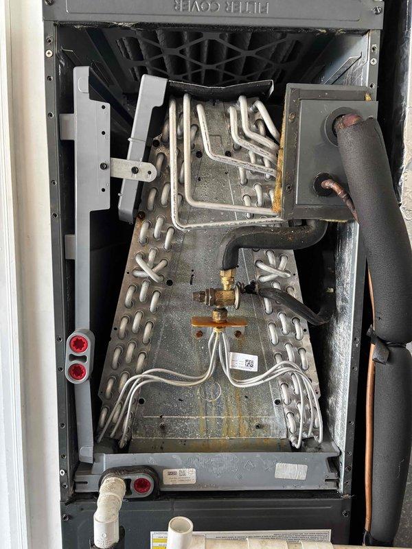 Completed comprehensive tune-up service on a 5-year-old residential air conditioning system. Performed full system inspection, accessed interior components through main service panel, and evaluated evaporator coil assembly which showed moderate dust accumulation on aluminum fins. Inspected heat exchanger tubes, refrigerant lines with brass fittings and valves, electrical connections, and condensate drain system—all components found to be intact and functioning within normal parameters. System operating properly with no deficiencies noted at time of service.