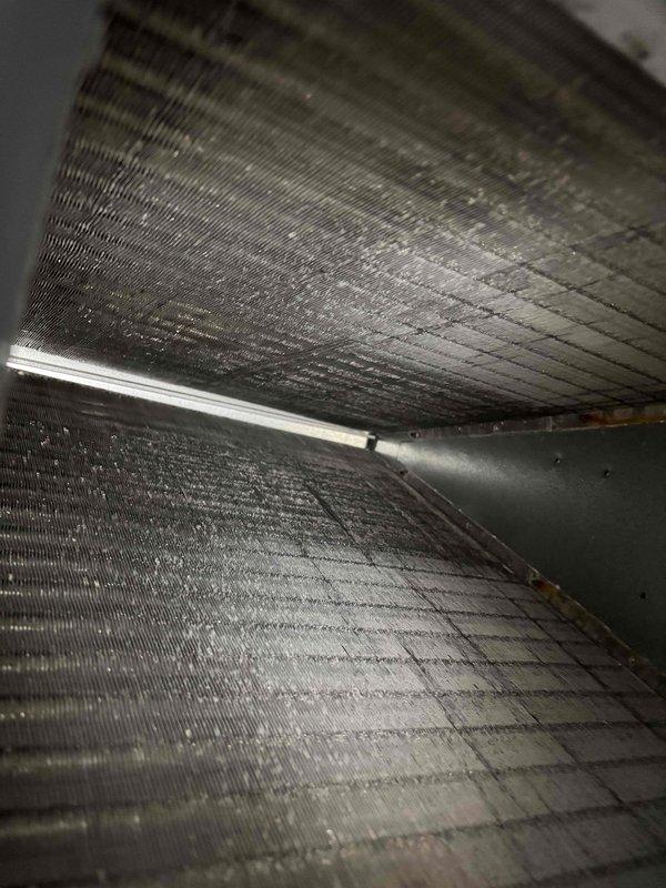 Completed comprehensive tune-up service on a 5-year-old residential air conditioning system. Performed full system inspection, accessed interior components through main service panel, and evaluated evaporator coil assembly which showed moderate dust accumulation on aluminum fins. Inspected heat exchanger tubes, refrigerant lines with brass fittings and valves, electrical connections, and condensate drain system—all components found to be intact and functioning within normal parameters. System operating properly with no deficiencies noted at time of service.