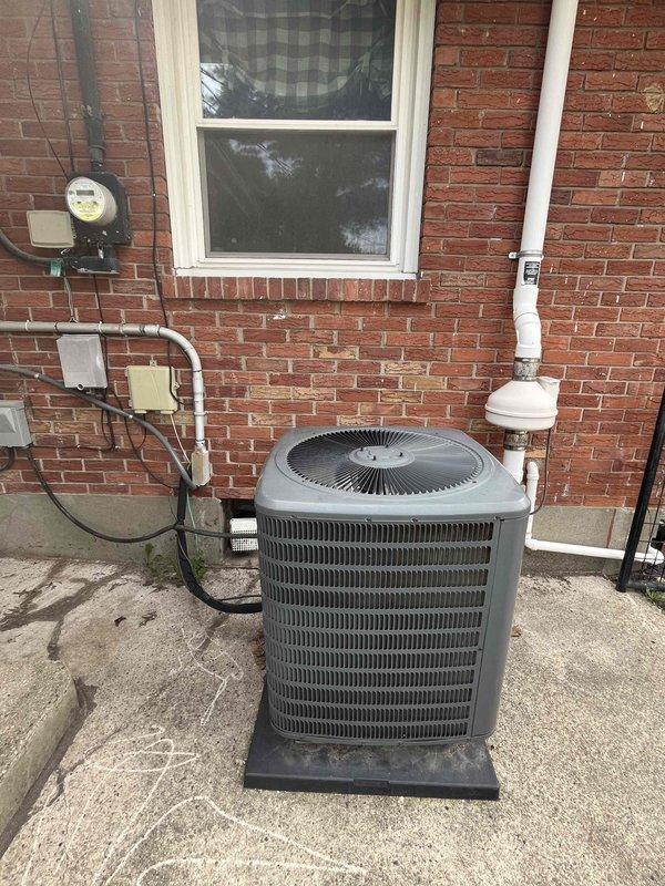 Completed comprehensive HVAC replacement estimate for residential property with non-functioning air conditioning system. Assessed existing dark gray condenser unit positioned on concrete pad adjacent to brick exterior, evaluated electrical service including main panel with dual breaker columns controlling various household circuits including dedicated AC condenser circuit, and inspected associated components including meter housing, service panel box, gray conduit runs, and white PVC condensate drainage line. Documented all equipment specifications, electrical infrastructure capacity, mounting configurations, and replacement requirements through detailed photographic documentation to provide homeowner with complete system replacement options.