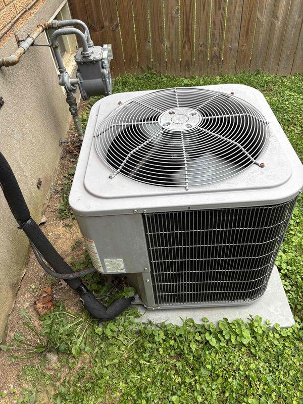 Responded to no cooling complaint on 5-6 year old residential split system. Upon arrival, found outdoor condenser unit humming but not operating properly, with system unable to maintain desired temperature. Performed diagnostic evaluation using digital manifold gauges, measuring system pressures at 117.6 PSI on low side and 307.2 PSI on high side. Pressure readings indicated refrigerant system imbalance contributing to inadequate cooling performance. Inspected condenser unit exterior condition, noting vegetation encroachment around concrete pad and equipment base requiring clearance maintenance for optimal airflow and operation.
