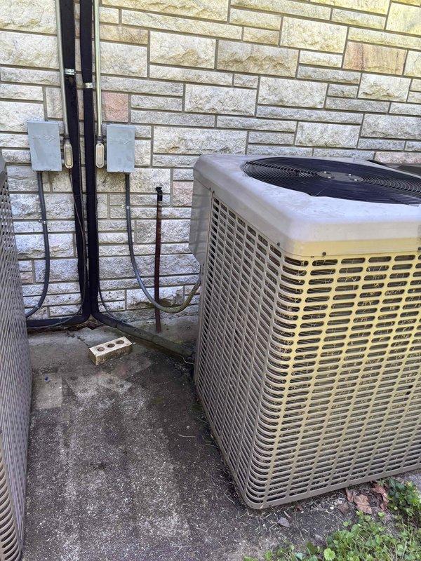 Responded to no-cooling call on approximately 10-year-old York condenser unit that was completely inoperative. Upon arrival, performed diagnostic evaluation of the non-functioning system and documented unit condition with exterior photographs showing condenser placement, electrical connections, and refrigerant line routing. Assessed electrical components including conduit runs and junction boxes mounted on building exterior. Inspected concrete pad condition and noted normal weathering consistent with system age. Completed visual inspection of second unit experiencing rapid cycling issues to determine service priorities. Documented both systems for maintenance records and provided recommendations for restoring cooling operation to primary unit.
