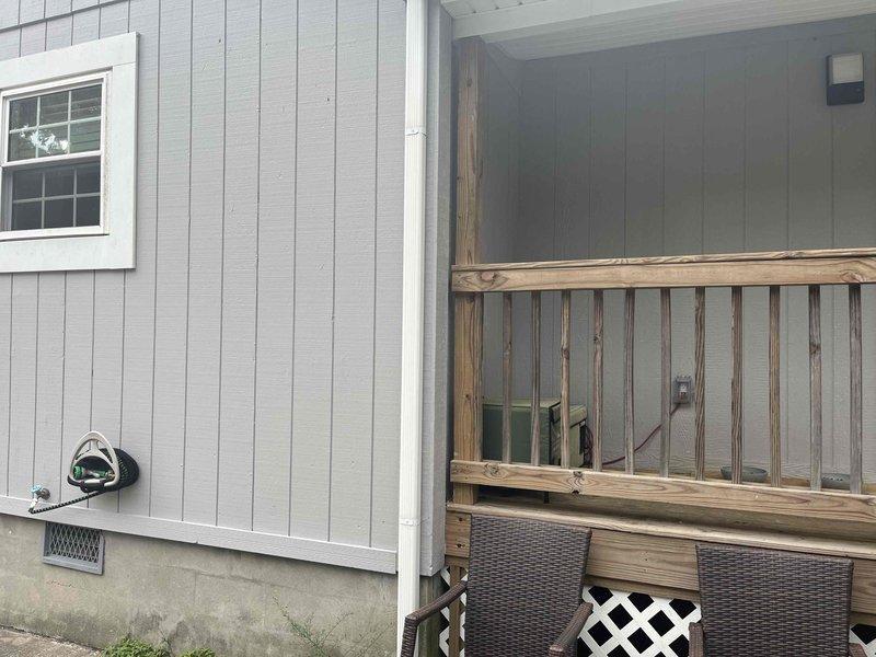Conducted on-site evaluation for ductless mini-split system installation to provide climate control for office space and potentially living room area. Assessed exterior wall conditions and electrical infrastructure including main service panel with adequate breaker capacity available. Documented existing utility meter location and suitable mounting areas on gray vertical siding for outdoor condenser unit placement near deck structure. Current HVAC system operational; homeowner seeking expansion of conditioned space rather than replacement of existing equipment.