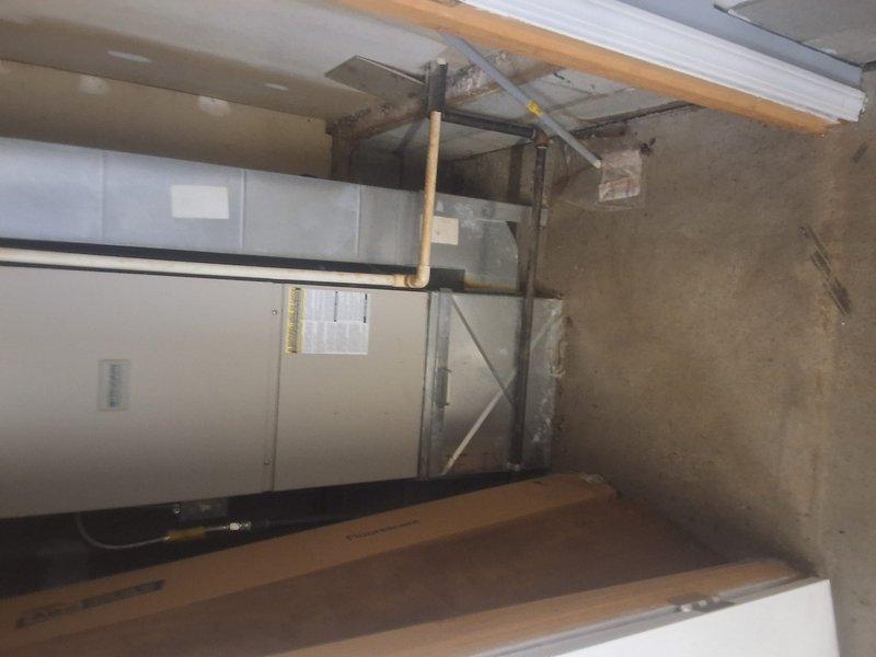 Responded to no cooling complaint for 30+ year old system serving garage area used by Food Pantry. Upon arrival, confirmed airflow present with no ice buildup on evaporator coil. Thermostat set to 80°F but space temperature measured 84°F and rising. Inspected upflow air handler unit and associated ductwork in basement utility area. Evaluated system performance and documented existing equipment configuration including furnace, evaporator coil, and plenum assembly. Photographed installation for reference including equipment nameplate data and system schematic showing upflow configuration with measurements. Assessed refrigerant lines, ductwork connections, and overall system condition given advanced age of equipment. System demonstrated inadequate cooling capacity for space requirements.