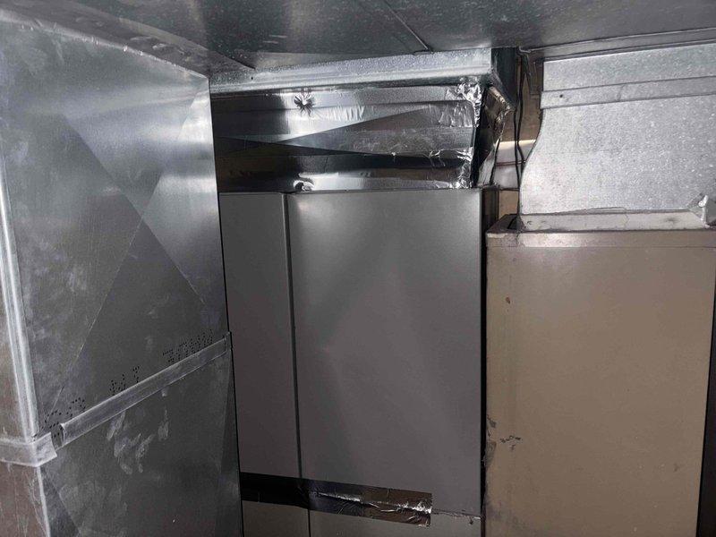 Completed installation of twinned 3-ton AC system in attic space, installing two 14-inch wide 3-ton cased evaporator coils on existing 80% efficiency furnaces. Fabricated and installed 20x12 return air drop measuring 55 inches with 1-inch filter rack for left-hand furnace. Connected refrigerant lines to both units, secured all piping with proper insulation and strapping, and verified system operation. All ductwork connections sealed and equipment positioned to accommodate existing 33.5-inch furnace height with 30-inch clearance to supply plenum.