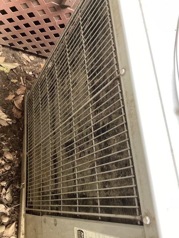 Responded to no-cool complaint on 11-year-old Carrier air conditioning system with inadequate cooling and warm airflow. Upon arrival, found outdoor condenser unit with heavily soiled top grille and significant debris accumulation including leaves, dirt, and organic matter restricting airflow. Condenser coils showed substantial contamination with dirt buildup on metal fins. Vegetation growth observed around unit base indicating lack of recent maintenance.

Performed complete system diagnostic including temperature differential measurements, refrigerant pressure checks, and airflow assessment. Confirmed system operational but running inefficiently due to restricted airflow at condenser unit. Thoroughly cleaned condenser coil fins using appropriate coil cleaner and low-pressure water rinse to remove dirt, debris, and biological growth. Cleared all leaf litter and organic material from top grille and surrounding unit perimeter. Removed vegetation growth from base of unit to ensure proper c