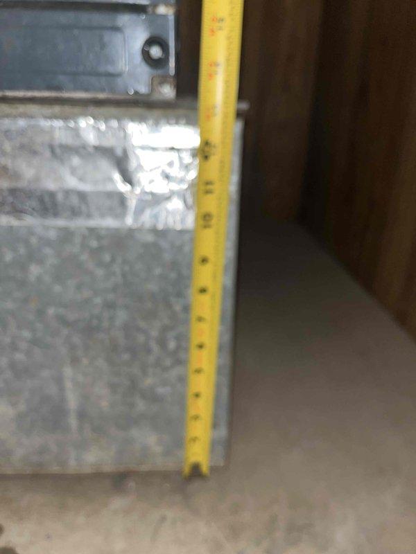 Responded to service call for AC not cooling properly with reported small leak. Documented existing Goodman split system equipment specifications including condenser unit model GSZ140301KG (serial 1907203158) rated at 208-230V, 1-phase operation. Photographed manufacturer data plate showing compressor and condenser fan motor specifications for reference. Assessed both air conditioning and furnace systems to provide comprehensive replacement estimate as requested. Captured documentation of existing equipment age and condition, including interior installation measurements and ductwork configuration.