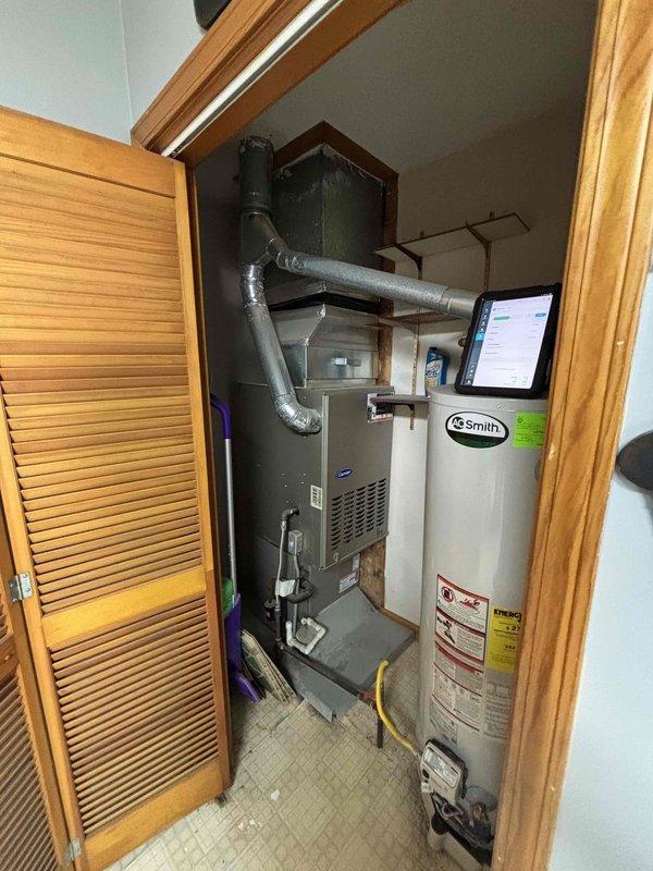 Completed comprehensive equipment assessment for air conditioning system replacement estimate. Evaluated existing 13-year-old Carrier AC system, including indoor air handler unit mounted in utility closet and associated refrigerant lines, condensate drainage, and electrical connections. Documented current system configuration with furnace and water heater placement in mechanical closet. Inspected outdoor condensing unit age and condition. Photographed existing equipment installation, ductwork connections, and available workspace for replacement unit installation. Provided detailed replacement options and recommendations based on current system capacity requirements and home specifications.