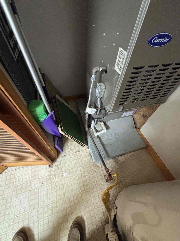 Completed comprehensive equipment assessment for air conditioning system replacement estimate. Evaluated existing 13-year-old Carrier AC system, including indoor air handler unit mounted in utility closet and associated refrigerant lines, condensate drainage, and electrical connections. Documented current system configuration with furnace and water heater placement in mechanical closet. Inspected outdoor condensing unit age and condition. Photographed existing equipment installation, ductwork connections, and available workspace for replacement unit installation. Provided detailed replacement options and recommendations based on current system capacity requirements and home specifications.