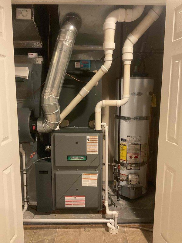 Completed comprehensive preventive maintenance on an eight-year-old residential air conditioning system currently operating within normal parameters. Performed full AC tune-up including inspection of furnace and HVAC components housed in utility closet, verified all electrical connections and wiring configurations across upper and lower compartments, checked condensate drainage system and PVC piping for proper operation, and documented equipment condition through photographic records. All mechanical components, control mechanisms, and ductwork connections were inspected and found to be functioning properly with no immediate service needs identified.