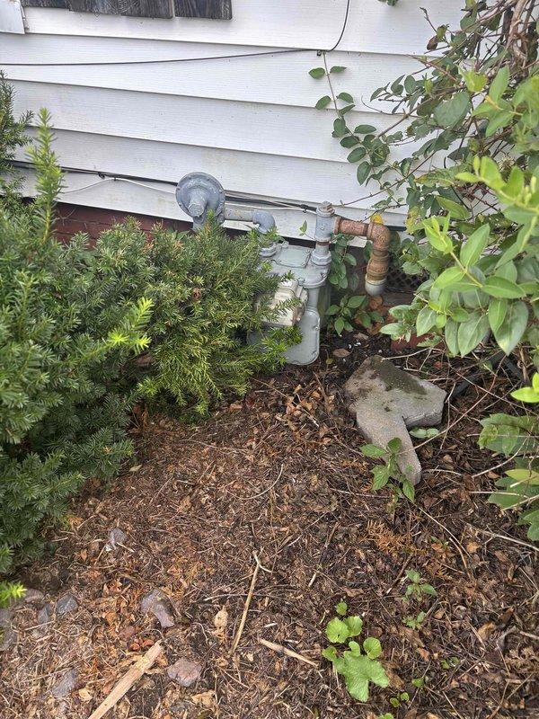 Conducted replacement estimate for residential HVAC system with failed motor and furnace components. Existing unit dating from 2002 was non-operational and powered off at time of assessment. Documented exterior utility connections including gas meter installation and reviewed replacement options with homeowner present.