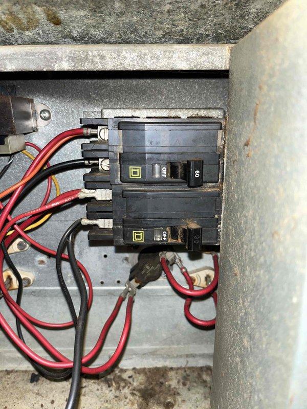 Conducted comprehensive HVAC system replacement estimate for non-functional heating and cooling system. Assessed existing electrical infrastructure including main breaker panel with 30-amp and 50-amp circuits in utility area, evaluating capacity and compatibility for new equipment installation. Documented current electrical panel configuration showing multiple circuit breakers and noted wall condition surrounding panel box, photographing installation points to determine proper sizing and electrical requirements for replacement HVAC system.