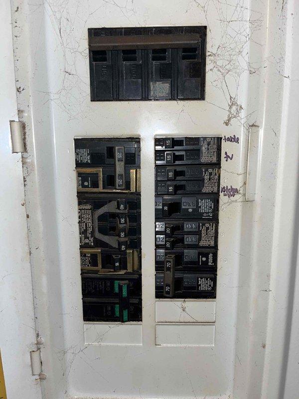 Conducted comprehensive HVAC system replacement estimate for non-functional heating and cooling system. Assessed existing electrical infrastructure including main breaker panel with 30-amp and 50-amp circuits in utility area, evaluating capacity and compatibility for new equipment installation. Documented current electrical panel configuration showing multiple circuit breakers and noted wall condition surrounding panel box, photographing installation points to determine proper sizing and electrical requirements for replacement HVAC system.