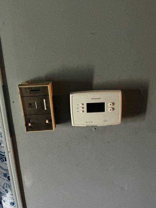 Responded to no-cooling call at residential property with aging package unit system. Upon arrival, found outdoor HVAC unit in weathered condition with legacy thermostat controls inside the home. Evaluated system for new homeowner experiencing complete HVAC failure, with both heating and cooling functions non-operational. Performed diagnostic assessment of package unit and thermostat wiring to determine operational status and recommended next steps for restoring climate control functionality to the property.