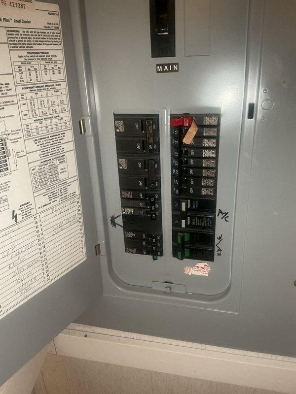Responded to no cooling complaint on 30-year-old residential air conditioning system. Upon arrival, confirmed airflow present at vents with no ice buildup at indoor unit. Performed visual inspection of outdoor condenser unit and verified electrical connections at disconnect box. Inspected main electrical panel to confirm proper breaker operation and power supply to HVAC system. Documented equipment condition and installation configuration with exterior condenser unit positioned against vinyl siding with standard electrical conduit routing.