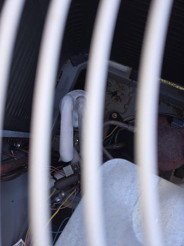 Responded to no cooling call with system completely off. Accessed blower motor assembly in garage per customer instructions. Diagnosed failed blower motor preventing system operation and replaced motor assembly to restore airflow and cooling function.