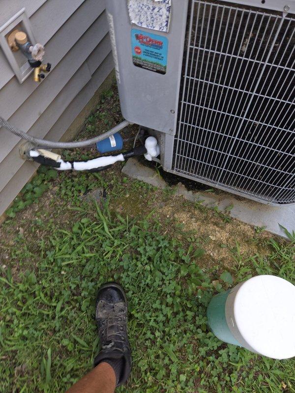 Responded to no cooling call with system completely off. Accessed blower motor assembly in garage per customer instructions. Diagnosed failed blower motor preventing system operation and replaced motor assembly to restore airflow and cooling function.