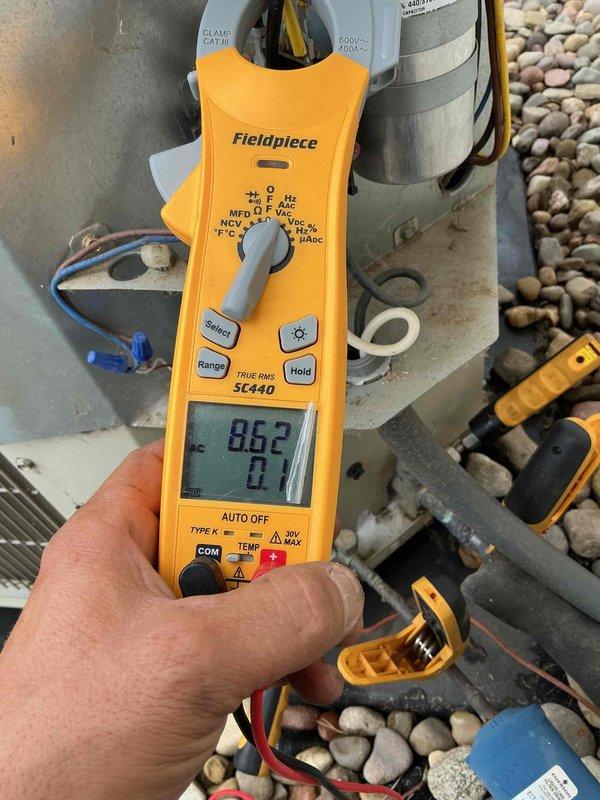 Completed planned maintenance on 6-year-old air conditioning system with 16x25x5 filter specification. Performed comprehensive system inspection including electrical component evaluation, with particular attention to the outdoor unit's capacitor and contactor assembly. Verified capacitor specifications and connections, confirming proper wire terminations with secure zip-tie bundling. Utilized digital clamp meter to obtain diagnostic readings, measuring 86.2 on system parameters to ensure equipment operating within manufacturer specifications. All electrical connections found secure, components showing normal wear consistent with age and outdoor exposure, system functioning properly upon completion of maintenance protocol.