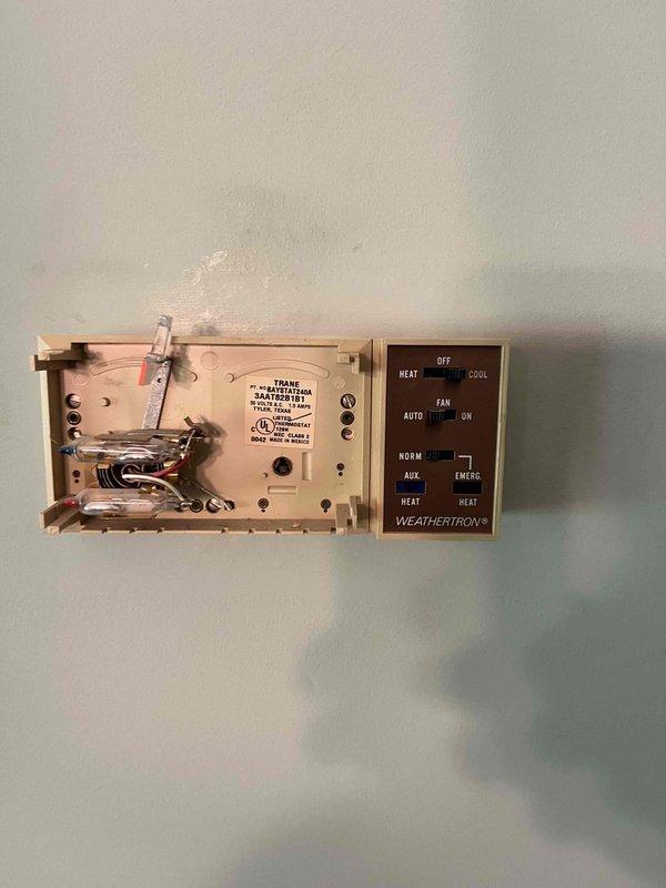 Conducted comprehensive HVAC system replacement estimate for residential property. Evaluated existing Weathertron thermostat control system and outdoor condenser unit positioned against exterior brick wall on decorative stone bed. Documented current equipment specifications, assessed system functionality, and provided recommendations for complete system replacement to improve energy efficiency and performance.