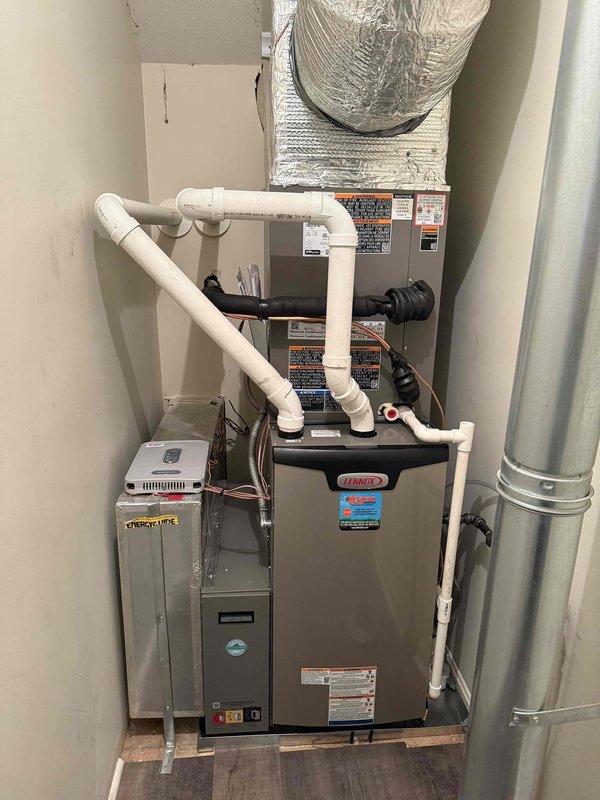 Completed full HVAC system installation consisting of a 3-ton, 17 SEER Lennox outdoor condensing unit (Model ML17KC2-036-230A02) paired with a 97% efficiency Lennox gas furnace and matching evaporator coil. The outdoor unit was factory-charged with R-454B refrigerant and installed per manufacturer specifications. Indoor equipment was mounted on a wooden platform in the utility closet, with the furnace positioned below the evaporator coil assembly. Installed complete condensate drain system using white PVC piping with proper trap configuration and routing. Connected metallic flexible supply duct from the furnace plenum and installed rigid metal return ductwork. Completed all electrical connections including dedicated disconnect and proper grounding. Verified system startup, confirmed proper airflow, checked refrigerant charge, and tested all safety controls for proper operation.